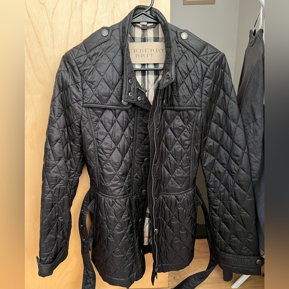 Burberry black quilted jacket. Has pockets and a detachable belt.